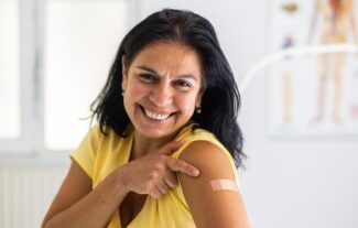Woman happy after getting covid 19 vaccination